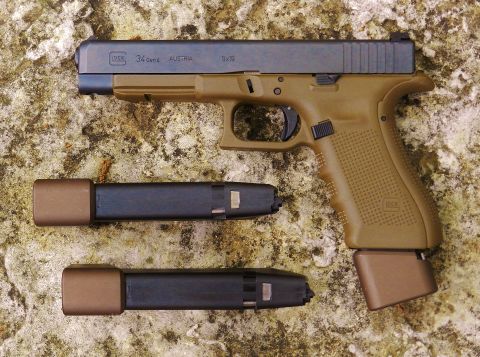 1996 Ford Bronco - A Glock 34 Gen 4 pistol and two magazines are displayed on a textured surface.