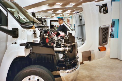 1992 Mercury Grand Marquis - A white truck's engine bay is displayed, with another truck visible behind it.