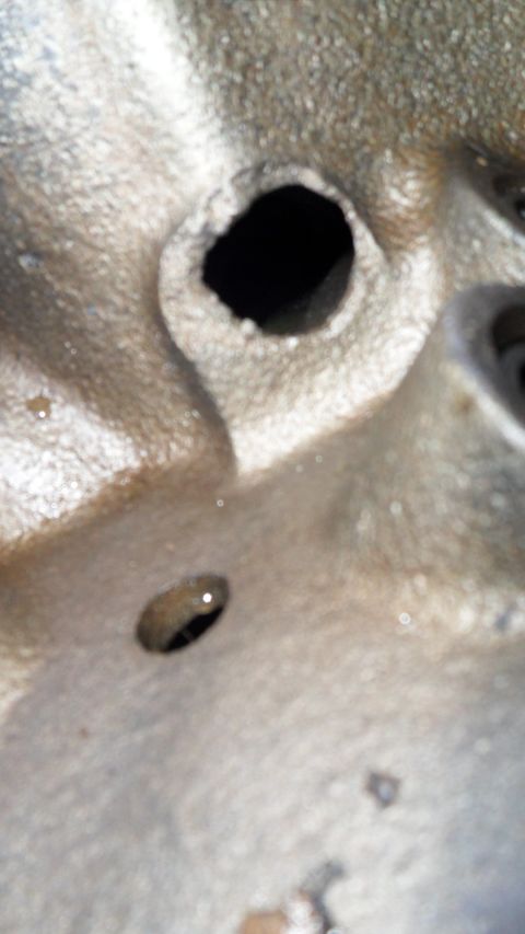 1972 Ford Ranchero - A detailed view of an engine component, two distinct holes, likely part of a larger mechanical system.