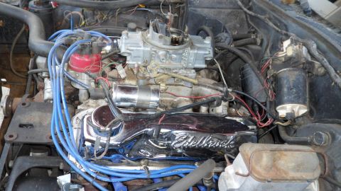 1972 Ford Ranchero - The engine bay shows a V8 motor with prominent aftermarket parts like an Edelbrock valve cover and a Holley carburetor.
