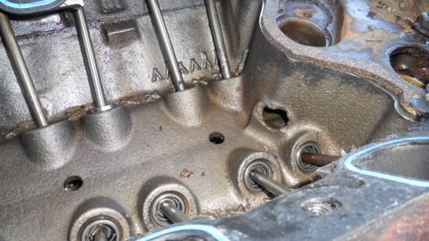 1972 Ford Ranchero - Close-up view of an engine block's interior, showing pushrods and valves. Stamped markings are visible on the block.