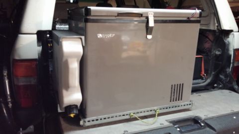 1985 Toyota 4Runner - Portable fridge and water jug installed in the rear of a vehicle.