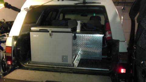 1985 Toyota 4Runner - The rear of a 1985 Toyota 4Runner is open, revealing a refrigerator and toolbox installed in the cargo space.