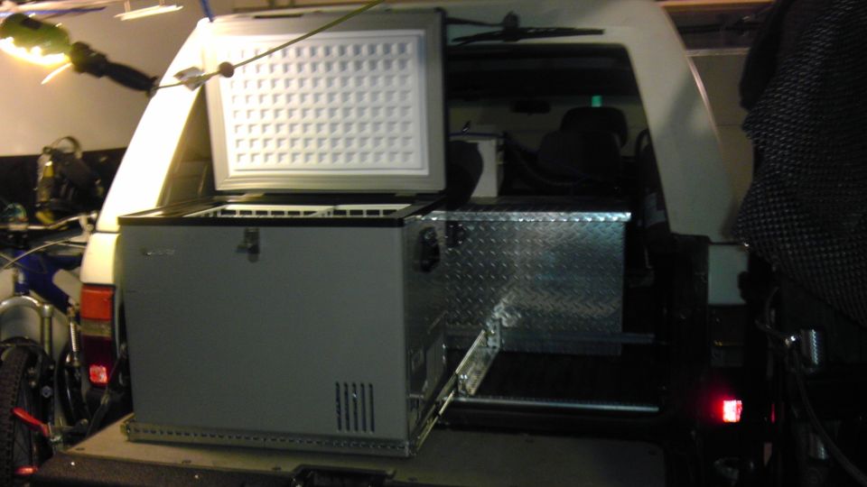Rear interior with open freezer and toolbox