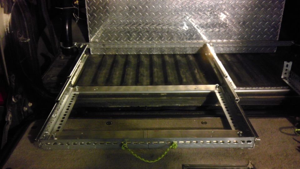 Custom truck bed slide-out drawer system with diamond plate lid and green rope handle