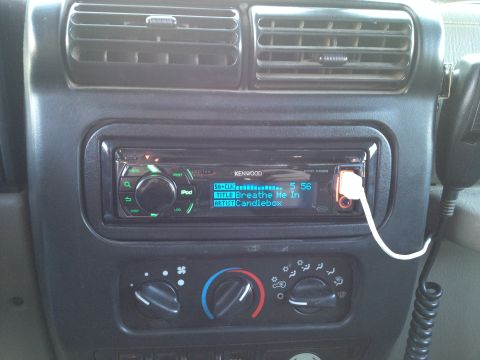 2005 Jeep Wrangler - Car interior showing a Kenwood stereo system with an iPod connected.
