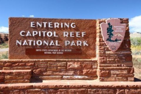 1991 Ford LTD Crown Victoria - Entrance sign for Capitol Reef National Park, Utah, with text and National Park Service emblem.