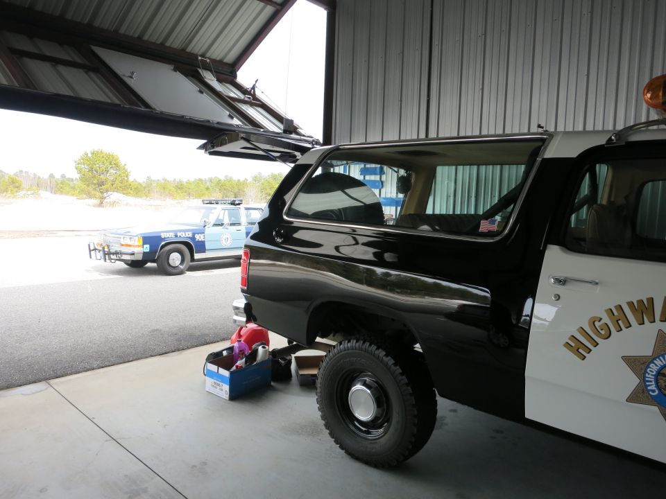 Side view of a black and white highway patrol SUV with "HIGHWAY PATROL" text on the door