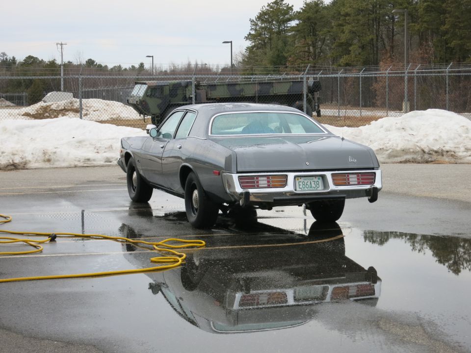 1977 Dodge Monaco sedan parked on wet asphalt, license plate E86A39