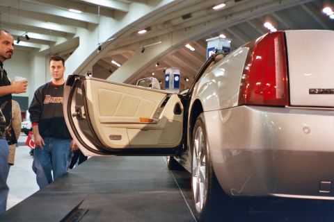 1992 Mercury Grand Marquis - A silver convertible is displayed with its driver's door open, revealing a beige interior.
