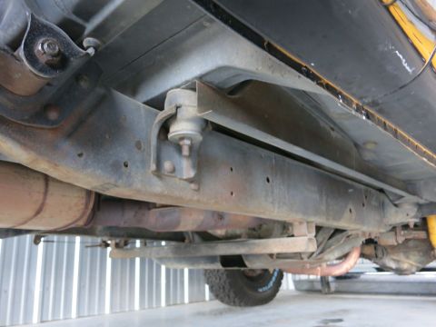 1991 Ford LTD Crown Victoria - Underside view shows the frame, exhaust pipes, and rear axle components of a vehicle.