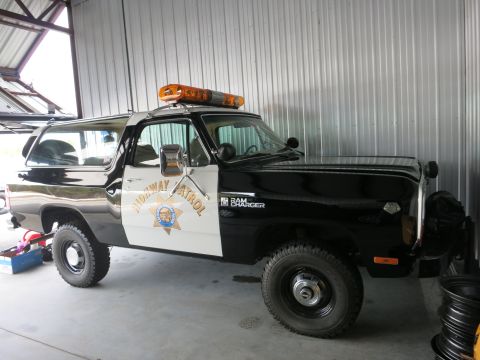 1991 Ford LTD Crown Victoria - A black and white Dodge Ramcharger, marked as Highway Patrol, is parked inside a garage.