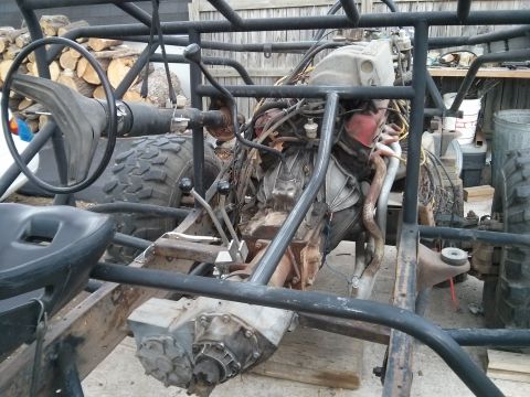 1986 Ford Bronco - Custom off-road vehicle chassis with engine and transmission, viewed from the interior.