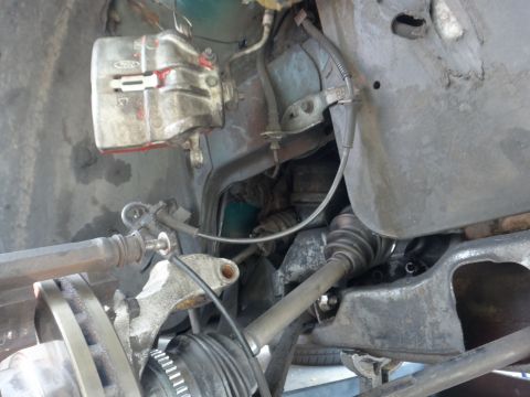 1993 Ford Taurus - Front suspension components including brake caliper and CV axle are shown in detail.
