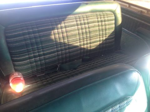 1979 Ford Bronco - The interior rear seat features a distinctive green plaid fabric pattern.