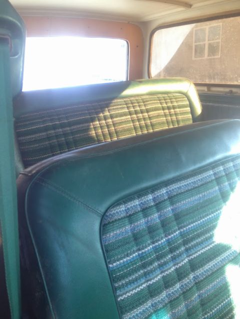 1979 Ford Bronco - The interior of a 1978 Ford Bronco features distinctive green plaid and vinyl seats.