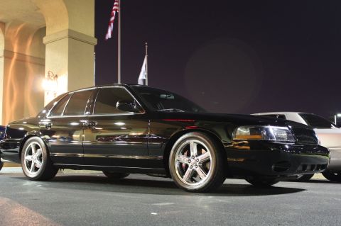 2003 Mercury Marauder - A black 2003 Mercury Marauder is parked in front of a building at night, with another vehicle visible behind it.