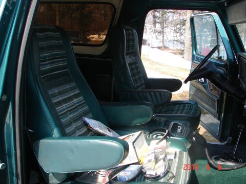 1978 Ford Bronco - The interior of a 1978 Ford Bronco shows its distinctive plaid and striped upholstery and dashboard details.