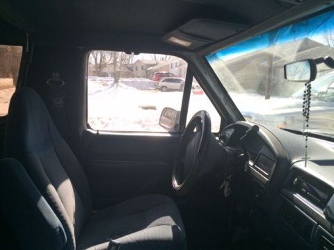 1996 Ford Bronco - The interior of a 1996 Ford Bronco is visible, with a view of the dashboard and driver's seat.