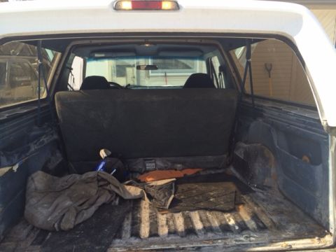 1996 Ford Bronco - View of the cargo area inside a 1996 Ford Bronco, showing the rear seats and floor.