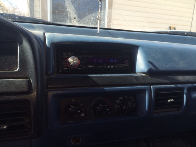 Dark blue dashboard with aftermarket stereo and climate controls