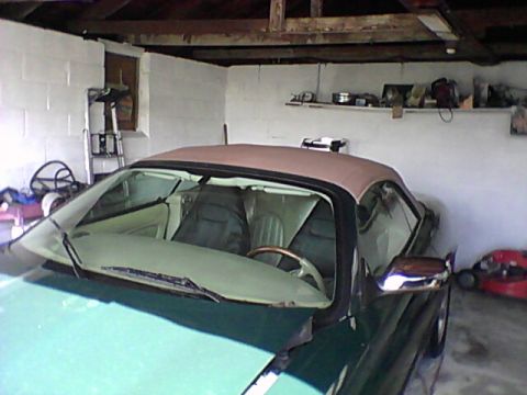 1998 Ford Crown Victoria - Interior view of a convertible with a tan top, seen inside a garage.