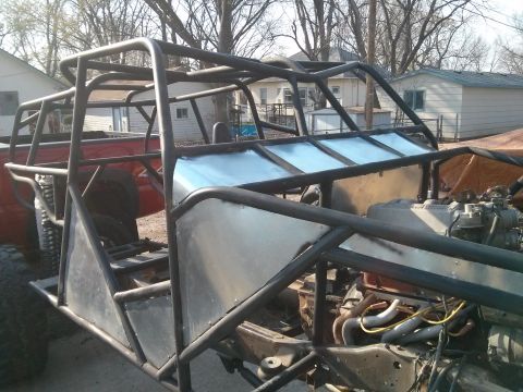 1986 Ford Bronco - A custom-built off-road buggy is shown with its exposed engine and extensive roll cage structure.