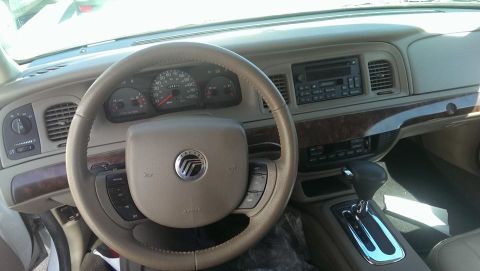 2000 Mercury Grand Marquis - The dashboard and steering wheel of a 2000 Mercury Grand Marquis are visible in this interior photograph.
