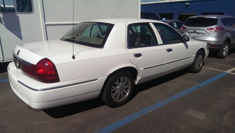 2000 Mercury Grand Marquis - Rear quarter view of a white 2000 Mercury Grand Marquis parked in a lot.