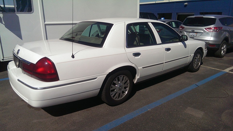 2000 Mercury Grand Marquis parked next to a silver SUV