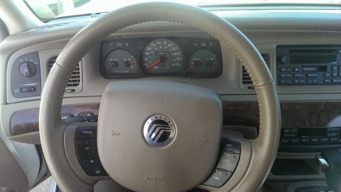 2000 Mercury Grand Marquis - Interior view of a 2000 Mercury Grand Marquis, highlighting the dashboard, steering wheel, and instrument cluster.