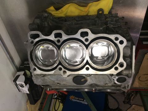 1996 Ford Probe - Engine block with pistons, likely during a rebuild or assembly process.