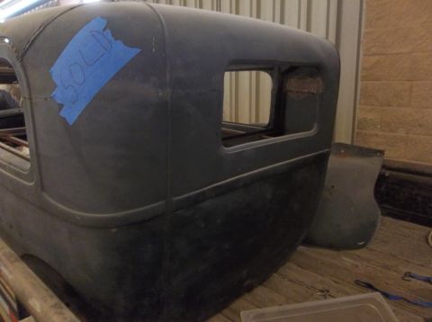 1929 Ford Sedan - The rear body of a 1929 Ford Sedan is shown, with "SOLD" written on blue tape on the roof.