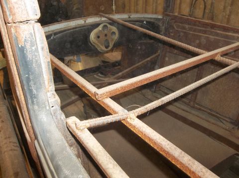 1929 Ford Sedan - The interior of a 1929 Ford Sedan, a dashboard and extensive rust on its structural frame.