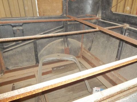 1929 Ford Sedan - The interior of a 1929 Ford Sedan is visible, with wooden floorboards and a metal frame structure.