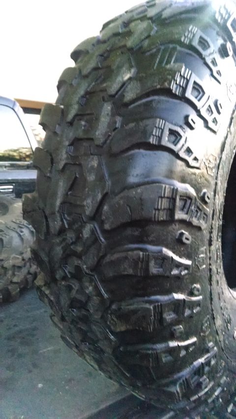 1985 Jeep CJ7 - This image shows a close-up of an aggressive off-road tire, likely for sale as a spare part.