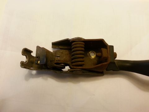 1995 Ford Bronco - A close-up view of a corroded mechanical lever assembly against a plain background.