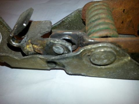 1995 Ford Bronco - A worn hood latch mechanism shows signs of rust and age.