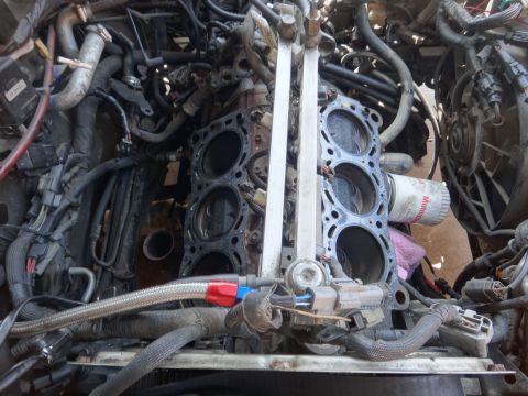 1993 Ford Taurus - Engine block disassembled, showing pistons and cylinder head removed. Oil filter is visible.