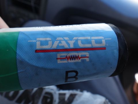 1993 Ford Taurus - Close-up of a Dayco branded automotive part with visible logo and markings.
