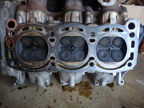 1993 Ford Taurus - Close-up of an engine's cylinder head, revealing the internal components and gasket surface.