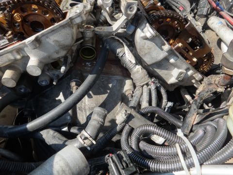 1993 Ford Taurus - Close-up view of disassembled engine parts, including timing chains and various hoses.