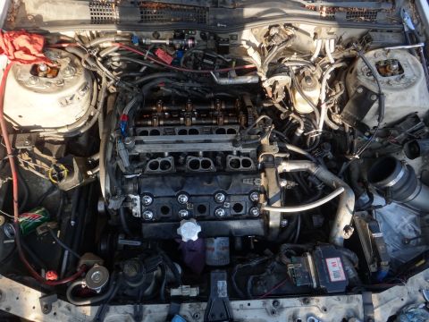 1993 Ford Taurus - The engine bay of a car is shown with the hood open, revealing the engine and surrounding components.