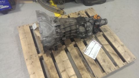 2000 Mercury Grand Marquis - A transmission is shown resting on a wooden pallet in a warehouse setting.