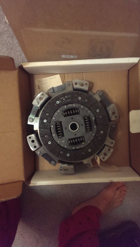 2000 Mercury Grand Marquis - A clutch disc assembly is shown inside a cardboard box, with a person's foot visible nearby.