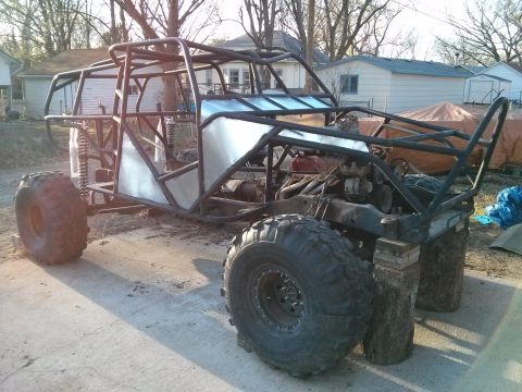 1986 Ford Bronco - This custom-built buggy frame is in a yard, showing its suspension and engine components.