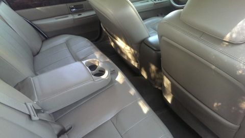 2000 Mercury Grand Marquis - Interior view of the rear seating area in a 2000 Mercury Grand Marquis, showing the seats and center console.