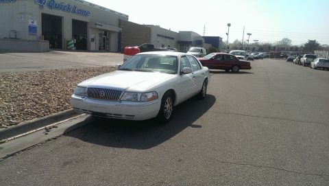 2000 Mercury Grand Marquis - White 2000 Mercury Grand Marquis parked in front of a Quick Lane service center.