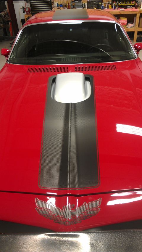 1972 Pontiac Trans Am - Front view of a red 1972 Pontiac Trans Am showing the hood scoop and emblem.