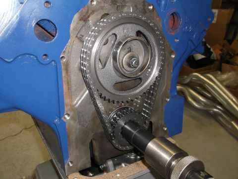 1967 Ford Mustang - Engine timing chain and gears assembly shown with blue painted block and exhaust headers.